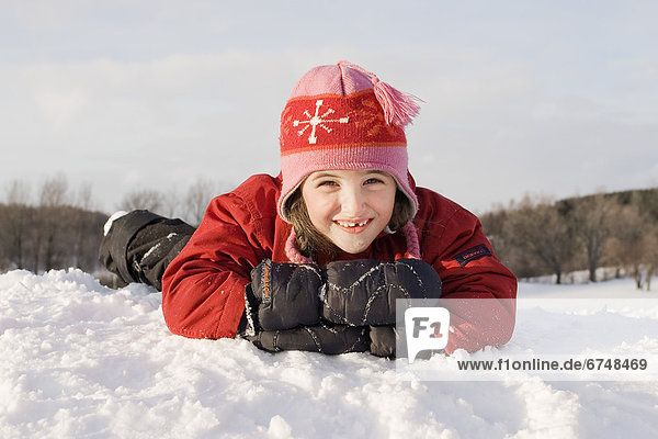 Young Girl Laying Down on Snow Bank  Toronto  Ontario