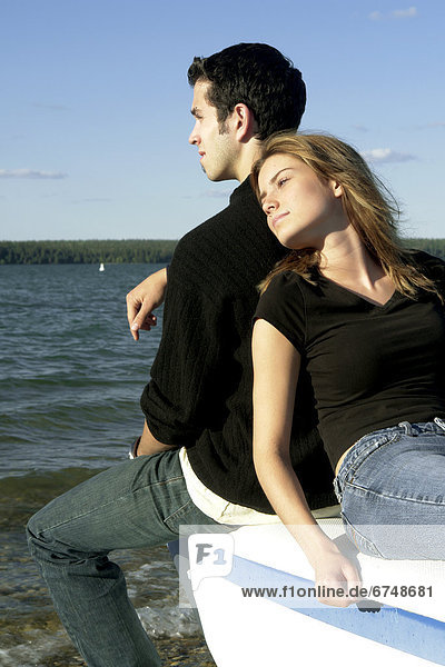 Couple Sitting by a Lake