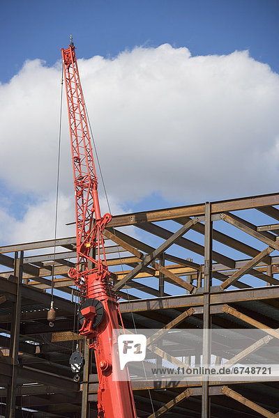 Unfinished structure and crane at construction site