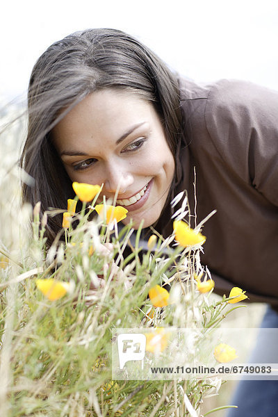 Woman Smelling Wildflowers