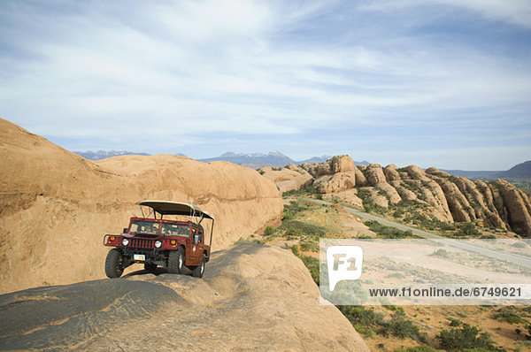 Off-road vehicle driving on rock formation