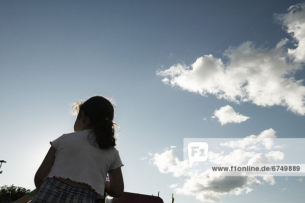 Girl Against Sky and Clouds