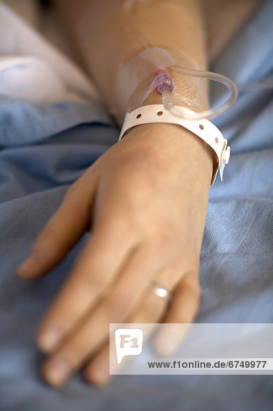 Woman s Hand with Hospital Wristband and Intravenous Needle