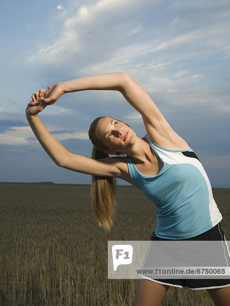Woman in athletic gear stretching