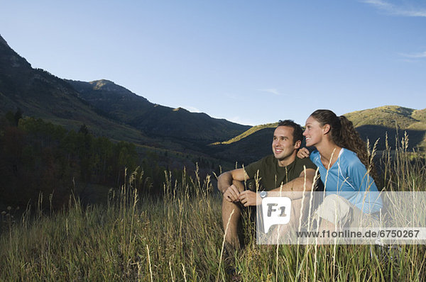 Couple sitting on hillside  Utah  United States