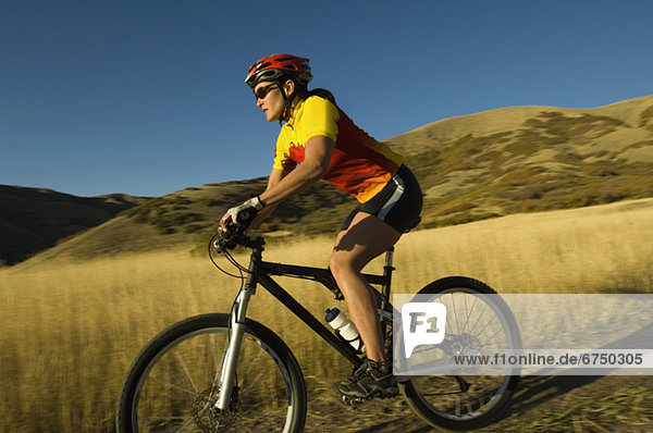 Woman riding mountain bike  Salt Flats  Utah  United States