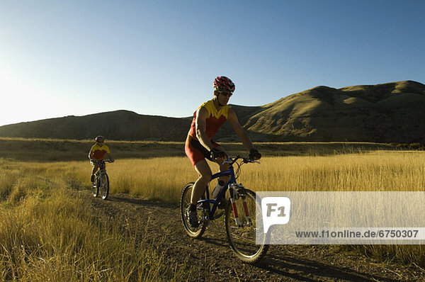 Couple riding mountain bikes  Salt Flats  Utah  United States