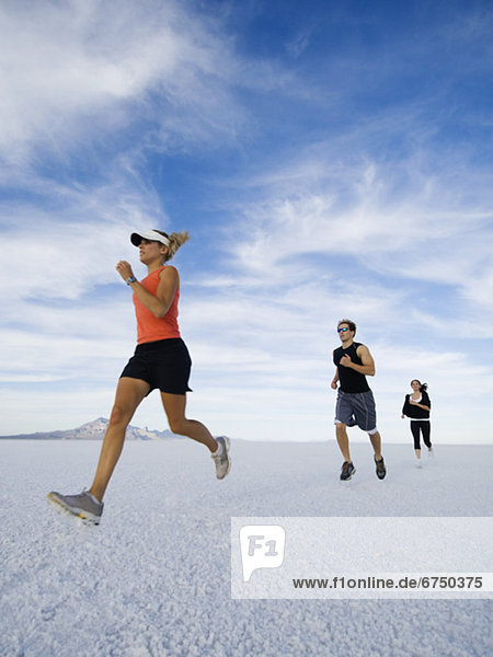 People running on salt flats  Utah  United States