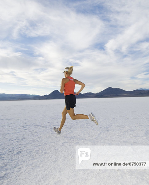 Woman running on salt flats  Utah  United States