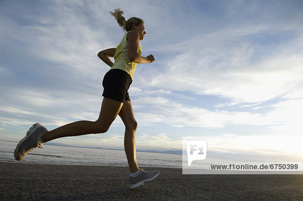 Woman running on road  Utah  United States