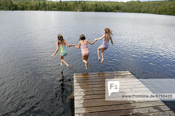Young Girls Jumping into Lac des Neiges  Quebec
