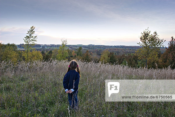 Young Girl Looking out over Forest