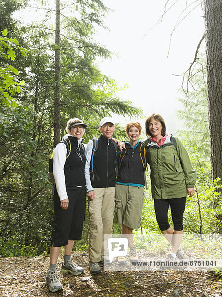 Female hikers posing in forest