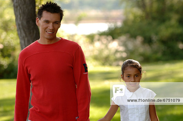 Father and Daughter Walking in Park