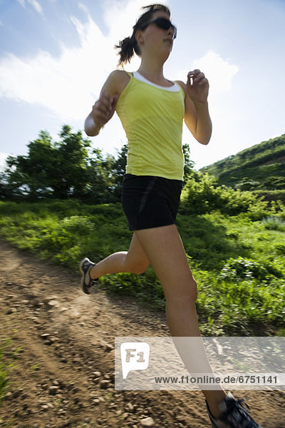 Young woman running on trail