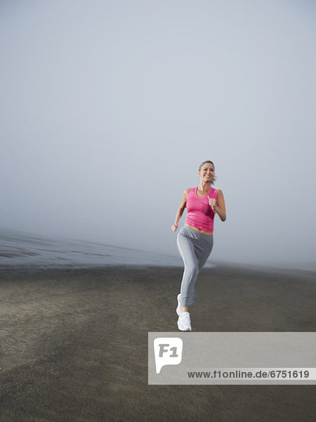 Frau  Strand  Nebel  joggen