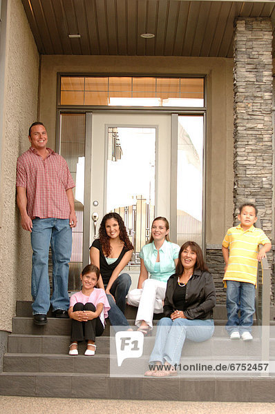 Family on Front Steps of House