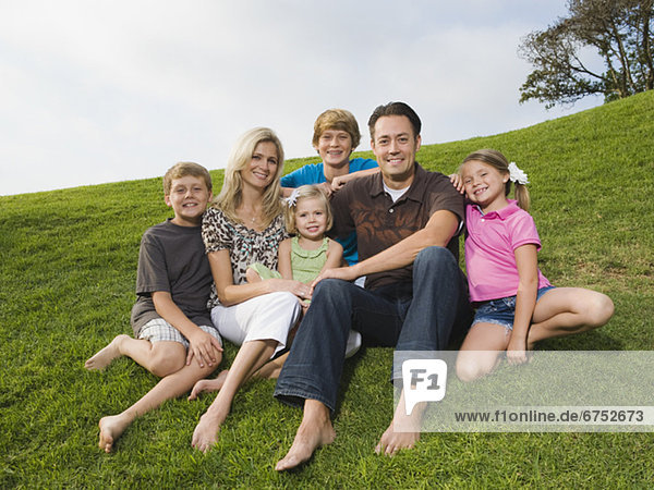 Family sitting on grass
