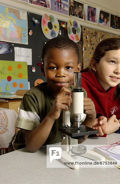 Young Boy with Microscope in a Classroom