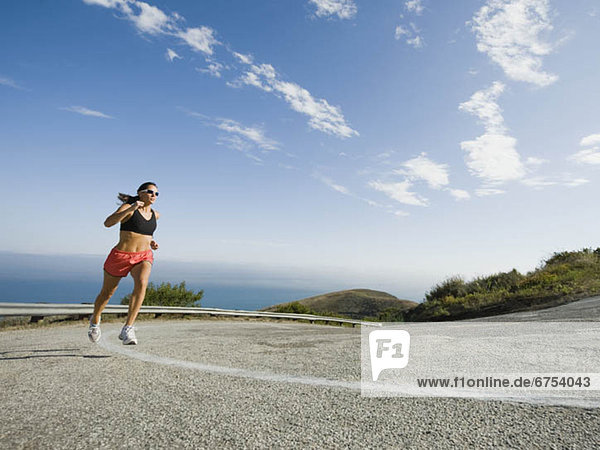 Woman running on a road in Malibu