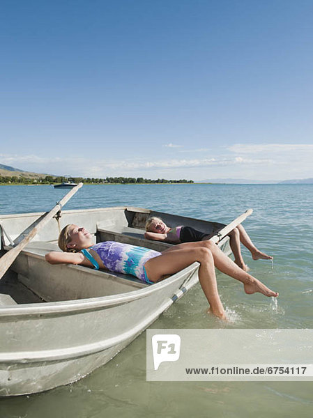 Girls (6-7 8-9) resting on boat