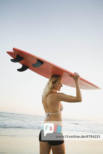 Portrait of woman with surfboard