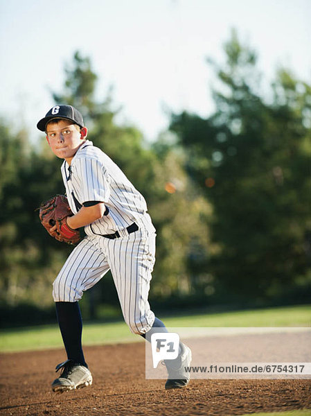 Boy (10-11) playing baseball