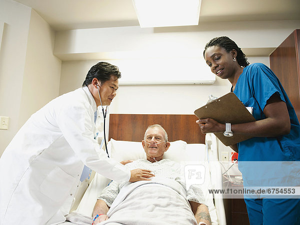 Senior patient with doctor and nurse