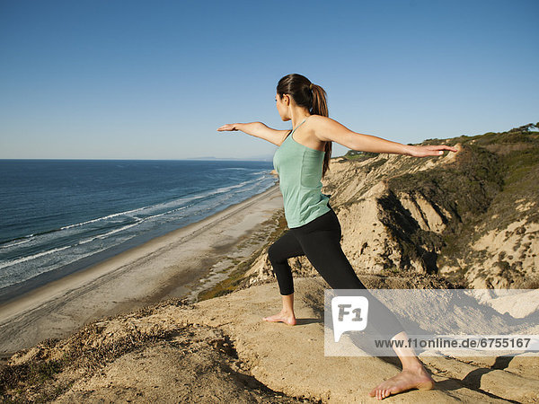 USA  California  San Diego  Woman practicing yoga on beach