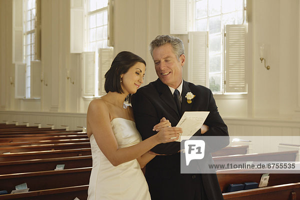 Bride and father reading letter