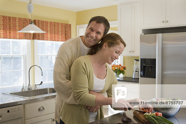 Couple making dinner in kitchen