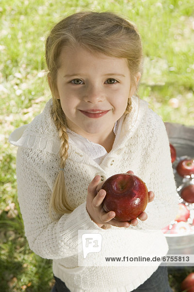 Girl bobbing for apples