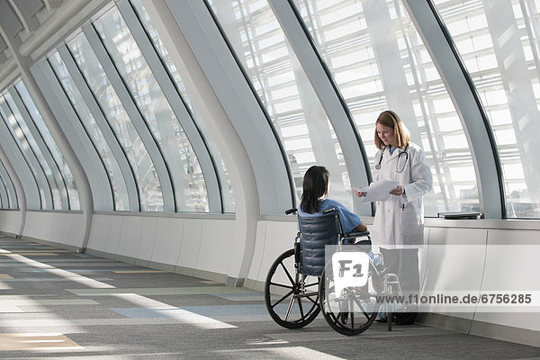 USA  Virginia  Virginia Beach  doctor talking to patient in wheelchair