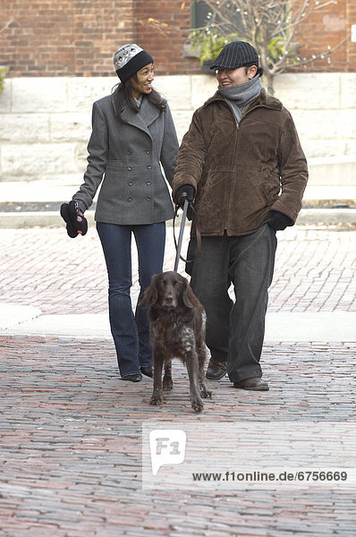 Couple Walking with their Dog  Distillery District  Toronto  Ontario