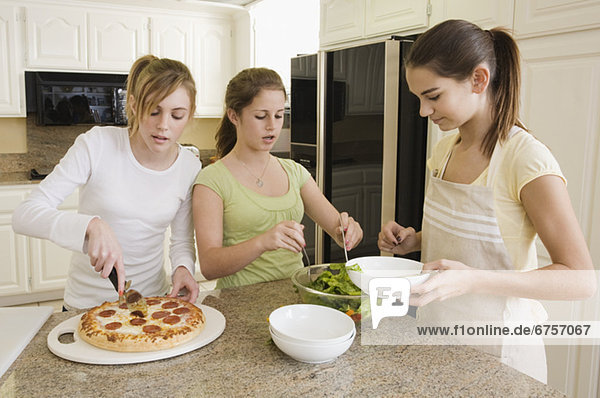 Teenaged girls serving food