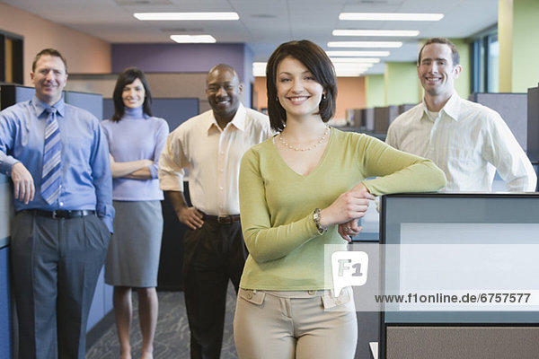 Businesswoman with multi-ethnic coworkers in background