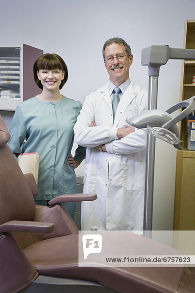 Dentist and dental hygienist in office