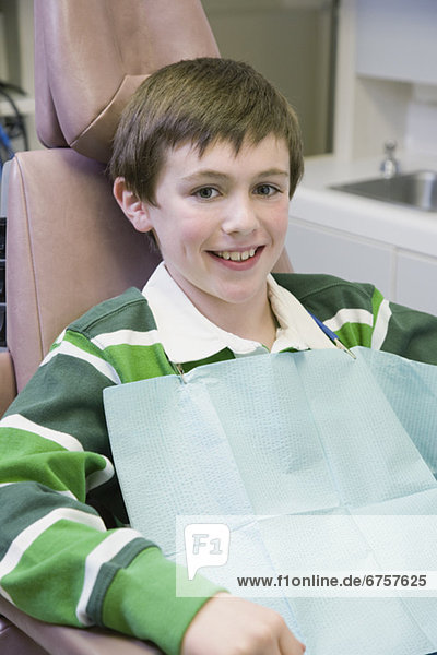 Boy sitting in dentistÕs chair