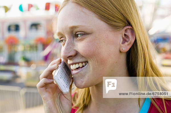 Girl Talking on Cell Phone at an Amusement Park  York Region  Ontario