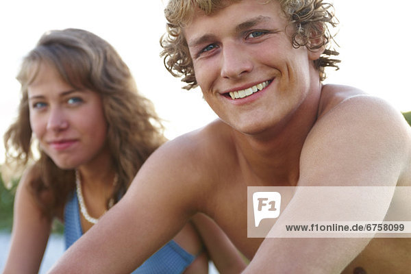 Young couple sitting at beach
