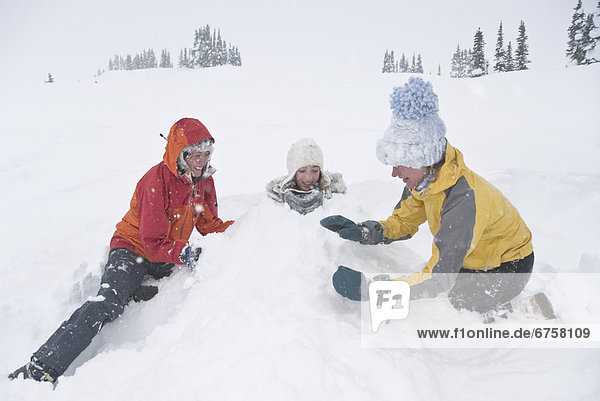 Three Woman Playing in the Snow  Purcell Mountains  British Columbia