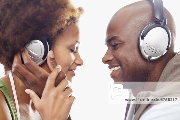 Couple wearing headphones