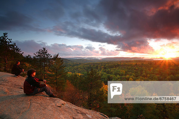 Hikers on Lookout Trail at Sunset in Autumn  Algonquin Park  Ontario
