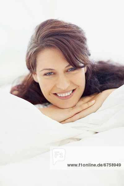 Woman relaxing on bed
