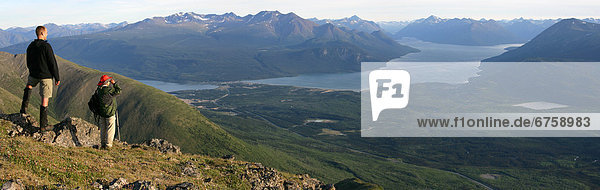 Panoramic of Hiker Overlooking Bennett Lake from Caribou Mountain  Carcross  Yukon
