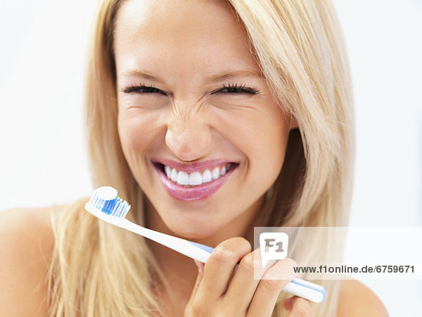 Woman about to brush her teeth
