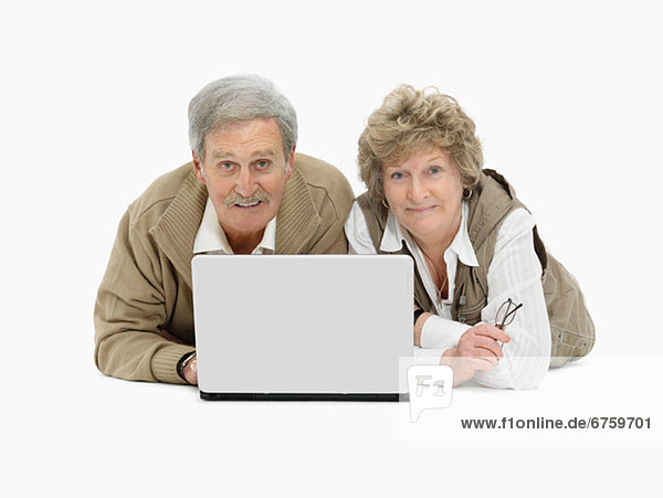 Retired couple looking at laptop together