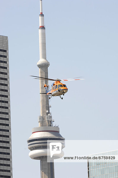 Air Ambulance Taking Off from St. Michaels Hospital in front of CN Tower  Toronto  Ontario