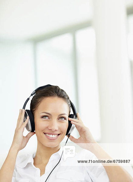 Woman listening to music on headphones