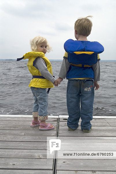 Brother and Sister on a Dock in Life Jackets  Lake Muskoka  Bracebridge  Ontario